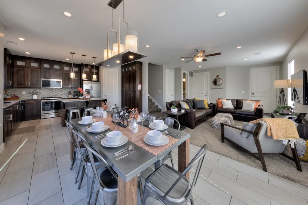 Gourmet kitchen and dining area in Moab townhome with dark wood cabinetry, breakfast bar seating, and stainless steel appliances.