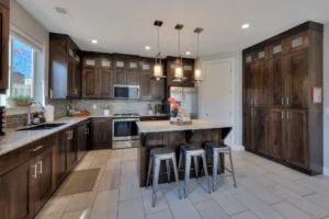 Fully equipped kitchen in Entrada Moab townhome 417 featuring dark cabinetry, granite island, and GE Profile appliances.