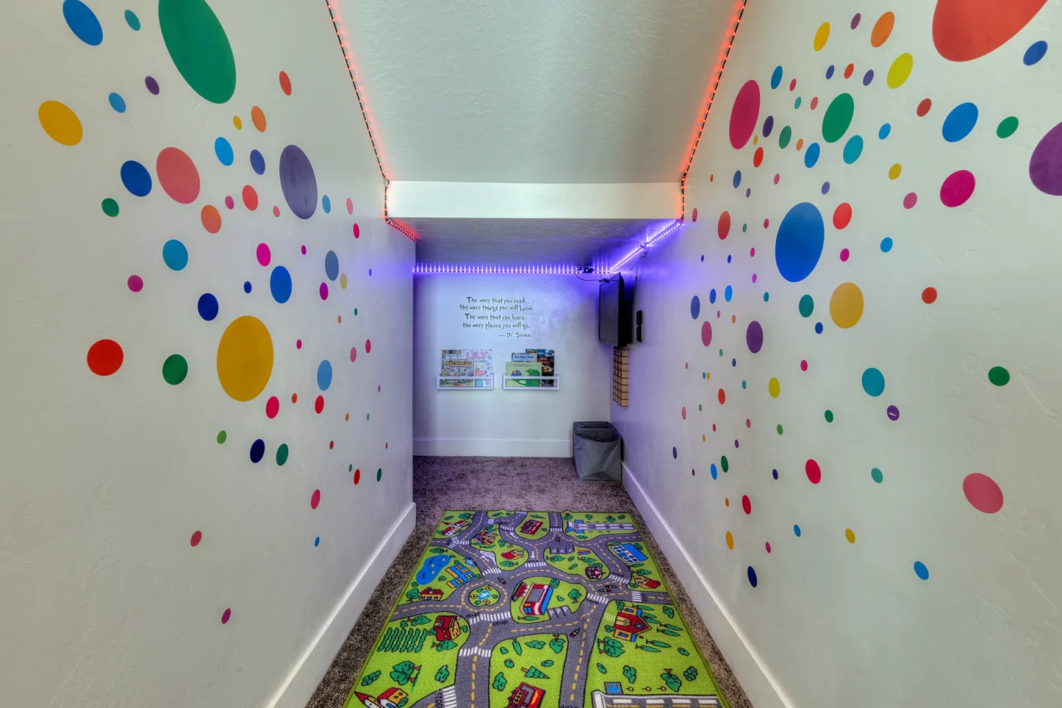 026-Entrada-Moab-417-Living-Dining-Kitchen Colorful hallway with polka dot wall decals leading to a secret kids play nook in Entrada Moab Townhome 417.