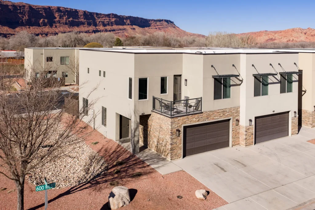 Aerial view of Entrada Moab townhomes featuring red rock cliffs and professional desert xeriscaping.