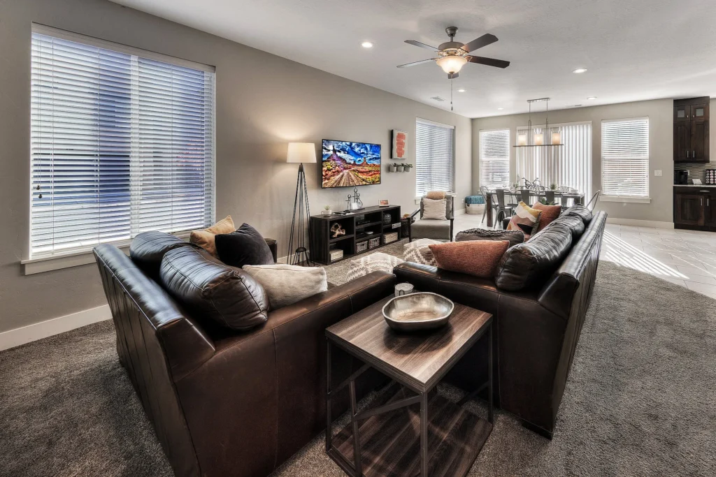 Bright open-plan living and dining area in an end-unit Entrada Moab townhome featuring natural side-window lighting.