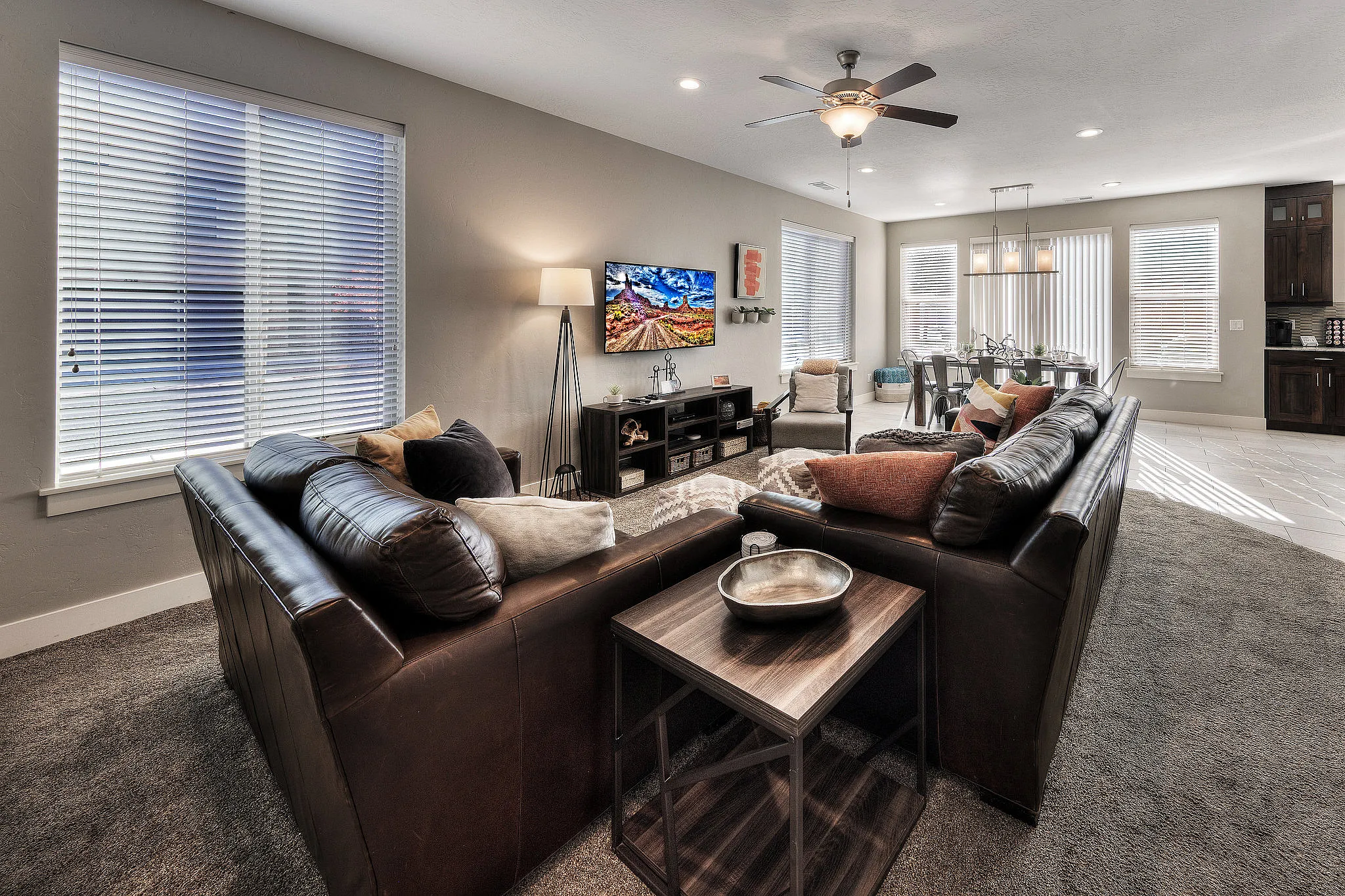 Bright open-plan living and dining area in an end-unit Entrada Moab townhome featuring natural side-window lighting.