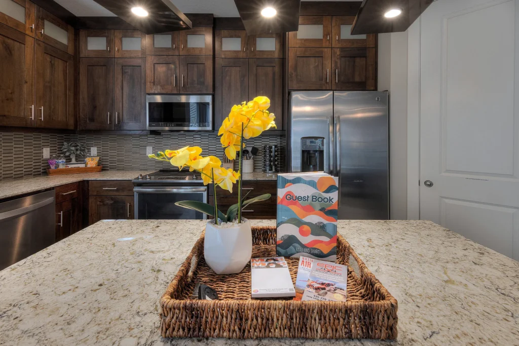 Detail shot of the kitchen island in Entrada 611 featuring the guest book and local guides.