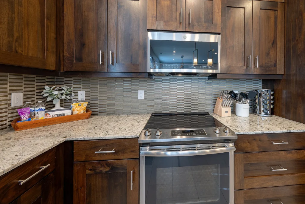 Close-up of the GE profile range and modern backsplash in Entrada 611 kitchen.