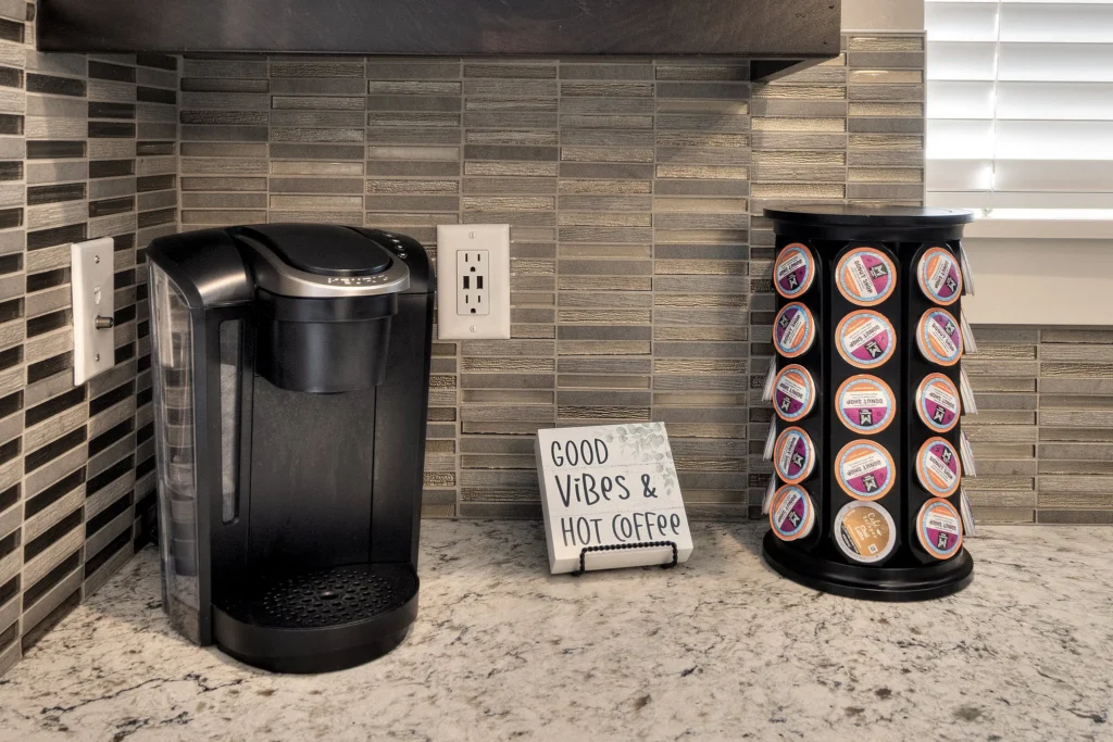 Coffee station in Entrada 611 featuring a Keurig machine, pod carousel, and mugs.
