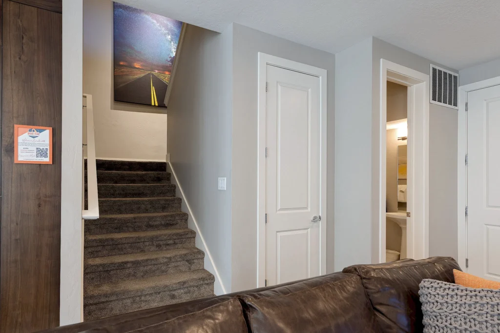 Carpeted stairs with desert-themed night sky wall art in Entrada 611.