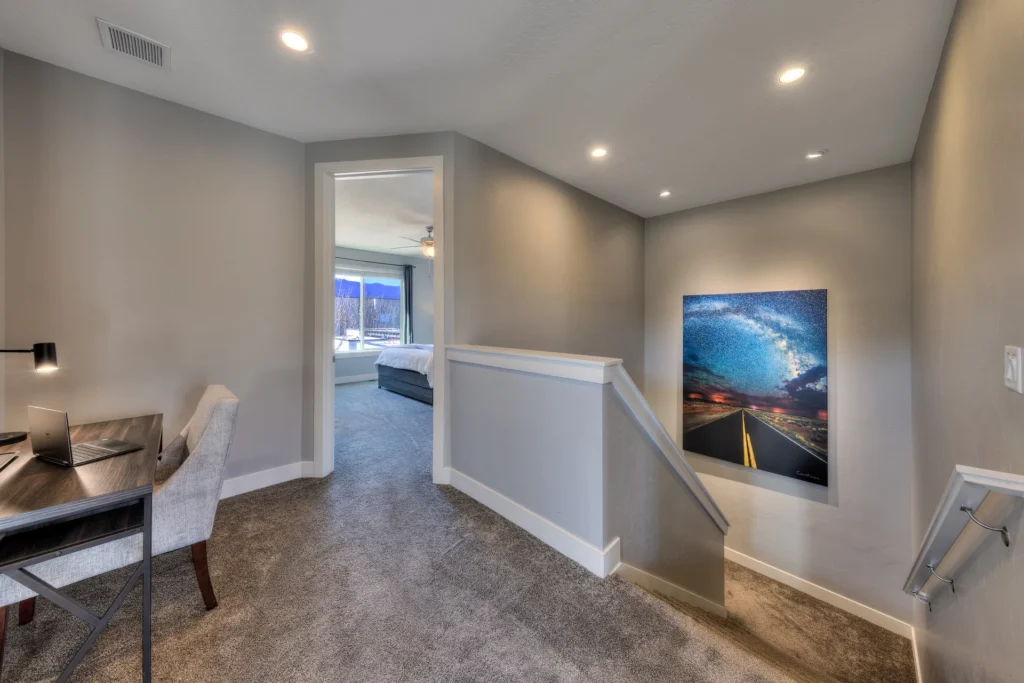 Upstairs hallway landing in Entrada Moab 417 featuring a dedicated workspace and local Milky Way photography.