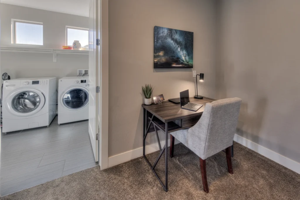 Remote work desk with laptop and task lamp in a Moab rental featuring high-speed Fiber Wi-Fi.