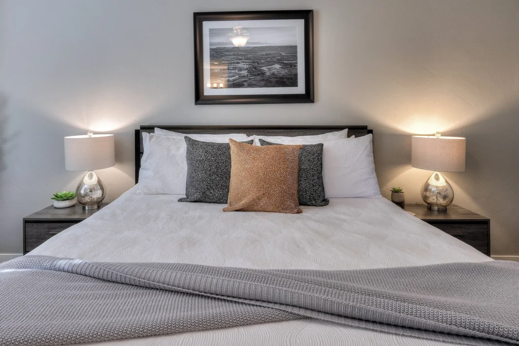 Detail shot of the king bed in Entrada 611 with framed photography of Dead Horse Point.