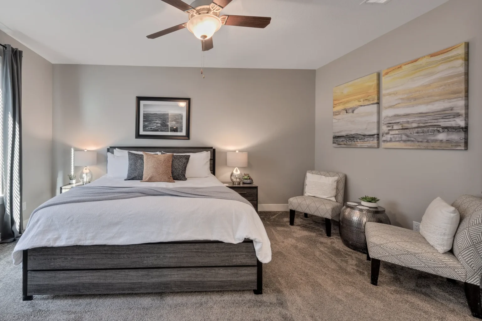 034-Entrada-Moab-417-MasterBedRoom Modern master bedroom seating area in Entrada Moab with designer chairs and contemporary canyon landscape art.