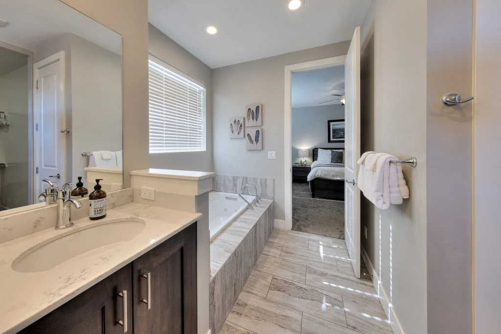Dual vanity and jetted tub in a Moab luxury rental master bathroom.