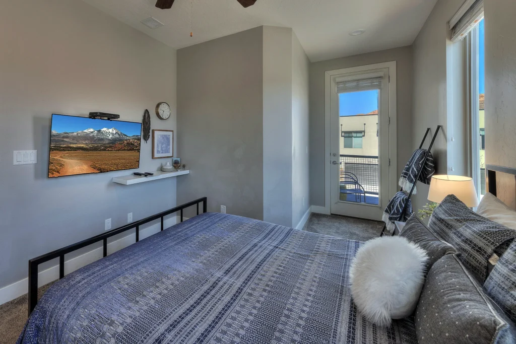 Dresser and smart TV showing the La Sal Mountains in Entrada 611 queen bedroom.