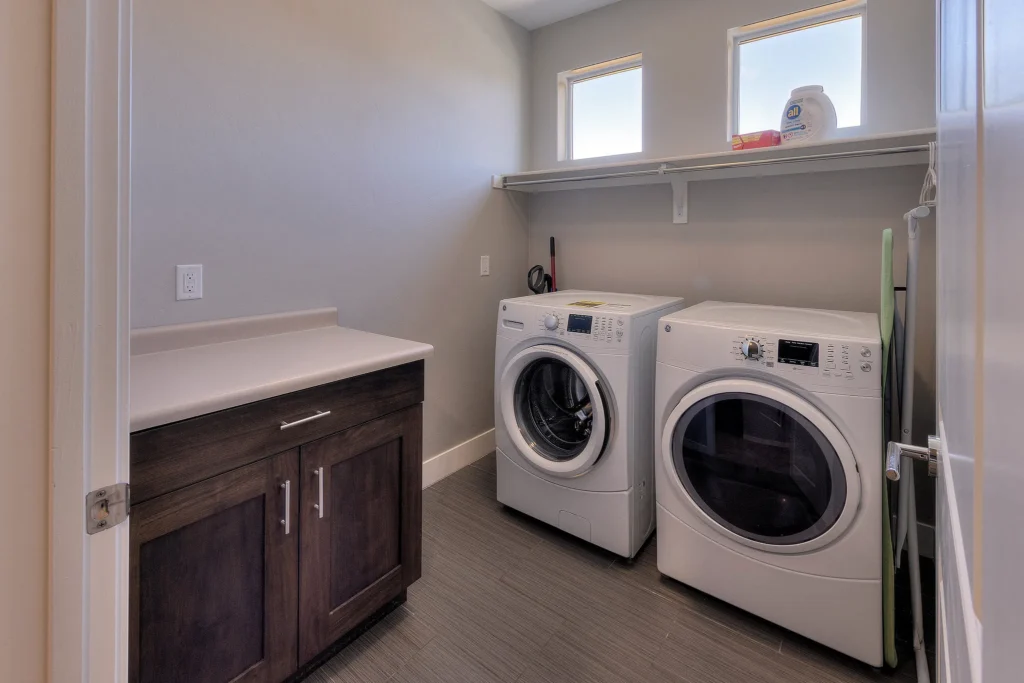 Modern laundry room with front-load washer and dryer in a Moab vacation rental.