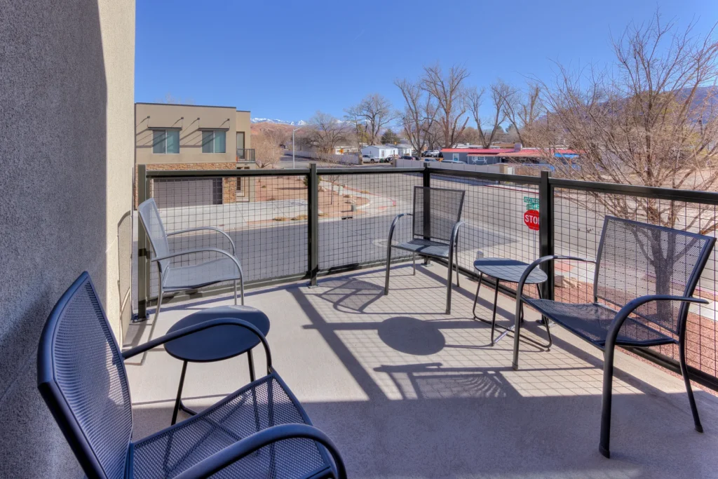 Private upstairs patio at Entrada Moab 417 featuring outdoor seating and views of the red rock landscape.