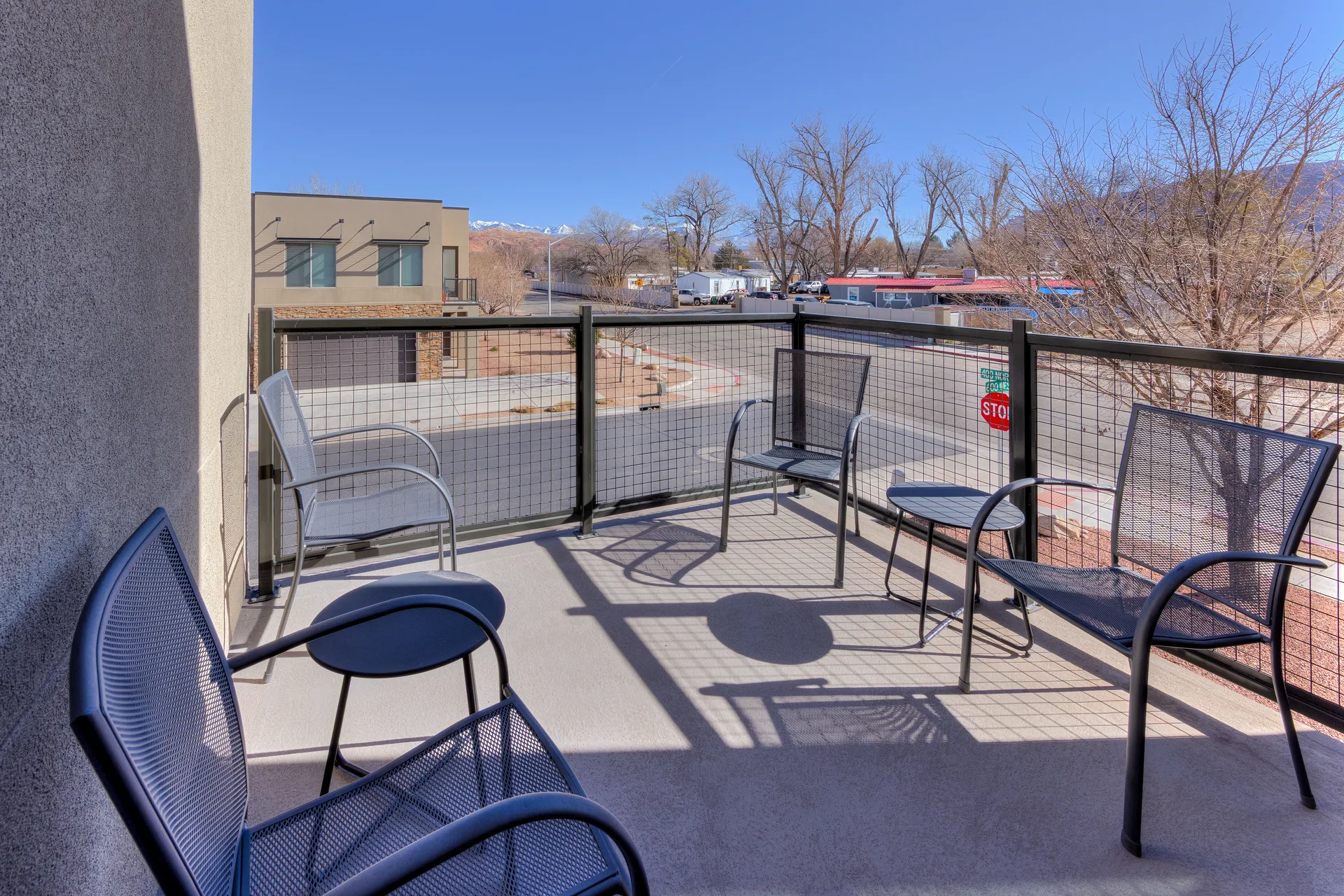 Private upstairs patio at Entrada Moab 417 featuring outdoor seating and views of the red rock landscape.