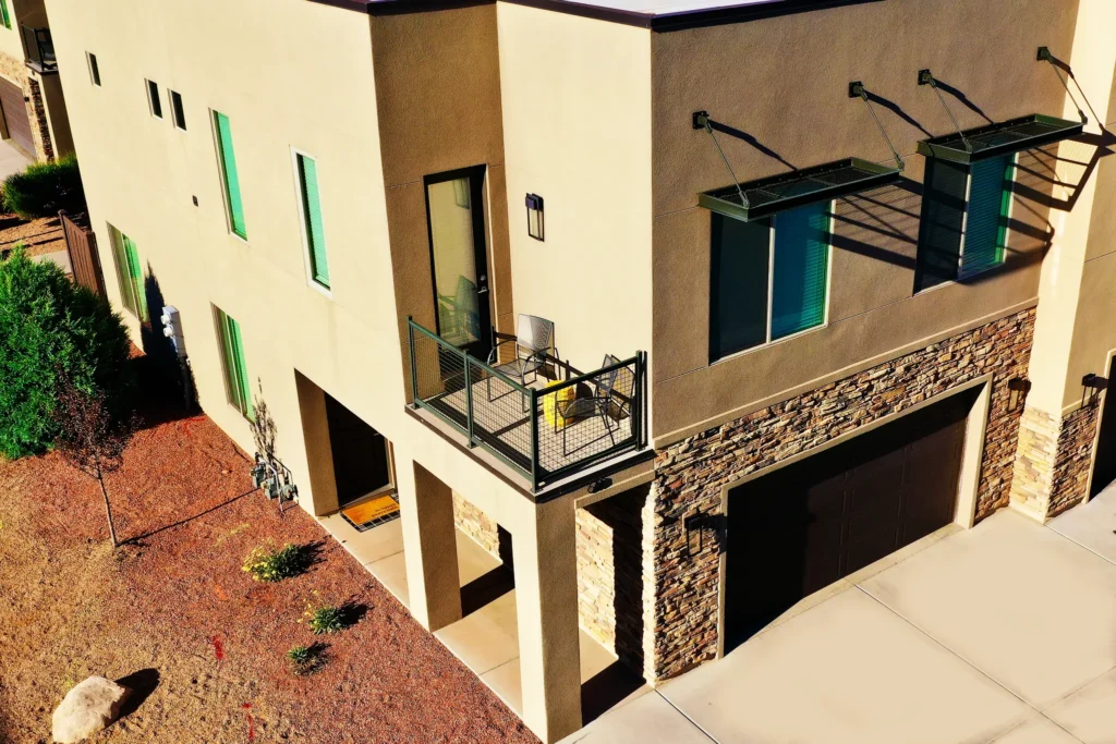 Elevated view of Entrada 611 showing the private balcony, oversized garage, and stone facade.