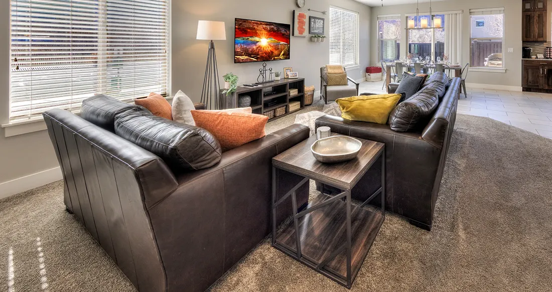009C-Entrada-Moab-417-Living-Dining-Kitchen Bright open-concept living room in Entrada 417 — luxury 3-bedroom vacation rental in Moab Utah with leather sofas and red rock views